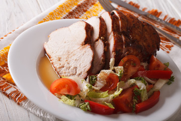 Roasted fillet of turkey and fresh vegetables close-up. Horizontal
