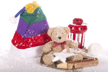 santa hat, flashlight, bear toy in snow and a star on a white background