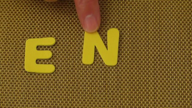 Woman hand writes the word END
