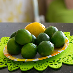 Juicy, ripe citrus on the plate - lime and lemon