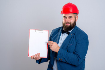 young architect with red helmet and clipboard