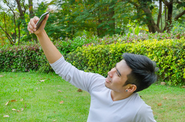 Man taking a selfie with his smart phone outdoor