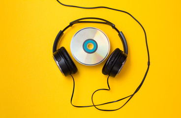 Headphones with CD disc on yellow