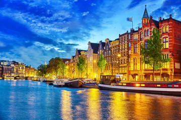 Fototapeta na wymiar Famous Amstel river and night view of beautiful Amsterdam city.