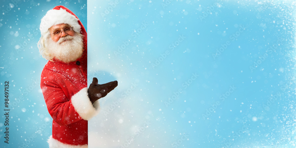 Wall mural santa claus holding banner with blue space for your text / merry christmas & new year's eve concept 