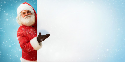 Santa Claus holding copyspace blank sign for Your Text / Merry Christmas & New Year's Eve concept /...