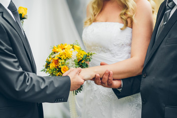 father gives his daughter's hand to the groom at a wedding cerem