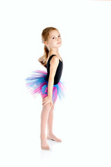 Little Ballerina in tutu on a white studio background.
