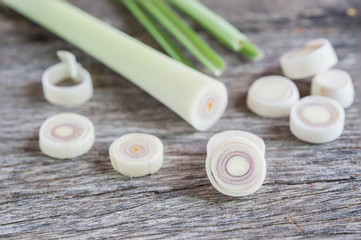 Fototapeta na wymiar Fresh lemongrass slices on wooden background - Spice for health.
