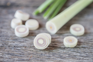 Fresh lemongrass slices on wooden background - Spice for health.