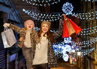 Mother and child with shopping bags rejoicing on Rialto Bridge