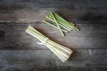 Fresh lemongrass on wooden background - Spice for health.