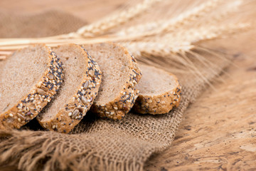 Rustic bread and wheat on an old vintage planked wooden table