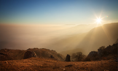 Obraz premium Mountain slopes in the mist at sunset