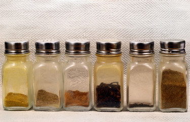 Glass shakers with spices and condiments.