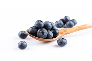 Fresh blueberries in wooden spoon