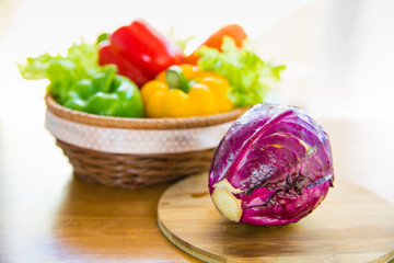 Red cabbage on chopping block with Healthy vegetable in basket p