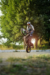 Fototapeta premium Impressive skills. Vertical soft smudged focus shot of a man riding extreme bike