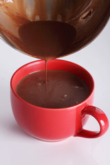hot chocolate drink pouring into red cup