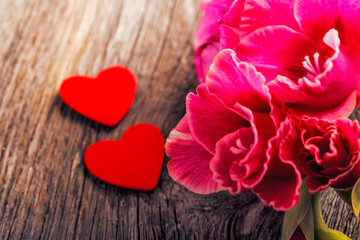 Plakat gladiolus and heart on a wooden background. Love concept background