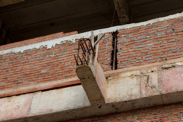 Reinforced steel bars on construction pillars, concrete details and beams at building site.
