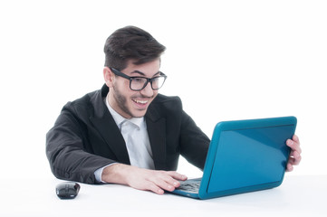 Smiling young man chatting on his laptop