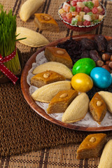 Novruz in Azerbaijan. Colored eggs for Easter and traditional sweets. Selective focus.