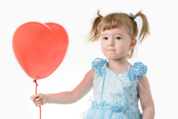 Little girl in blue dress holding a balloon