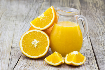 Fototapeta na wymiar orange juice and fresh fruits on wooden background