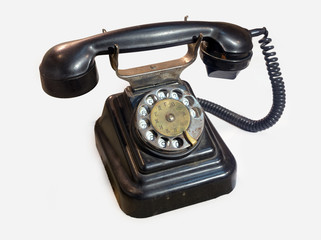 Old rotary phone on a white background.