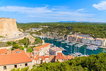 Fototapeta na wymiar A view of Bonifacio port with colorful houses and boats, Corsica island, France.