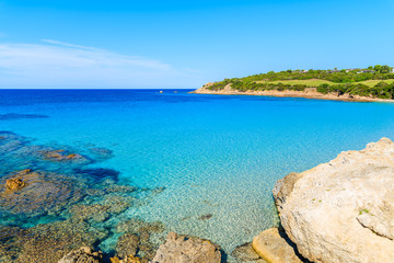 Rocks in crystal clear azure sea water in Grande Sperone bay, Corsica island, France