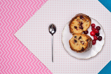 chocolate cake with cranberries on a saucer and a cup of tea