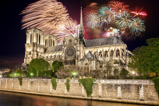 Toasting with champagne against Notre Dame with firework in Paris, France