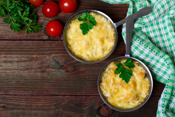 French cuisine. Сhicken with mushrooms baked with cheese in a cocotte