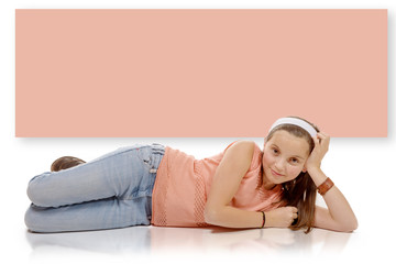 portrait of smiling little girl lying on the floor isolated on w