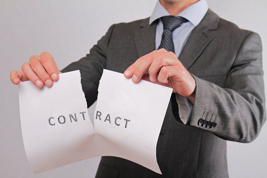Businessman breaking contract close up. Termination of Contract