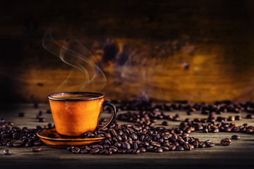 Coffee. Cup of black coffee and spilled coffee beans. Coffee break