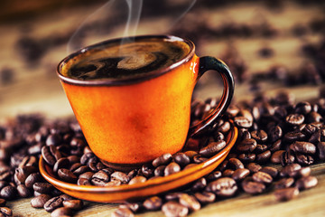 Coffee. Cup of black coffee and spilled coffee beans. Coffee break