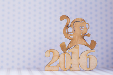 Wooden sign of monkey and inscription of 2016 year on light back