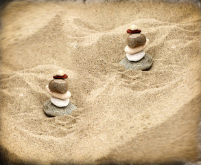 Fototapeta na wymiar Zen stones on sand - on a sandy beach