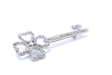 brooch in the form of a key on a white background