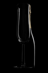 Glass of champagne from a bottle in the background