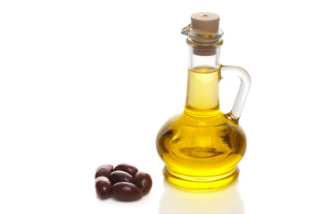 Olive oil in a bottle with olives on white 