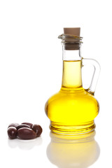 Olive oil in a bottle with olives on white 