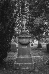 Obraz premium Tombstone and graves in graveyard landscape,black and white.