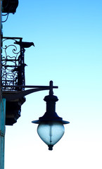 bird on a balcony with a lantern