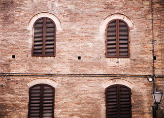 four windows in a brick wall