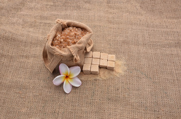 Sugar and Plumeria flower on hemp sackcloth  background.Selective focus with shallow depth of field.