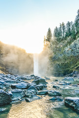 Fototapeta premium scenic view of Snoqualmie falls with golden fog when sunrise in winter season,Washington,USA.